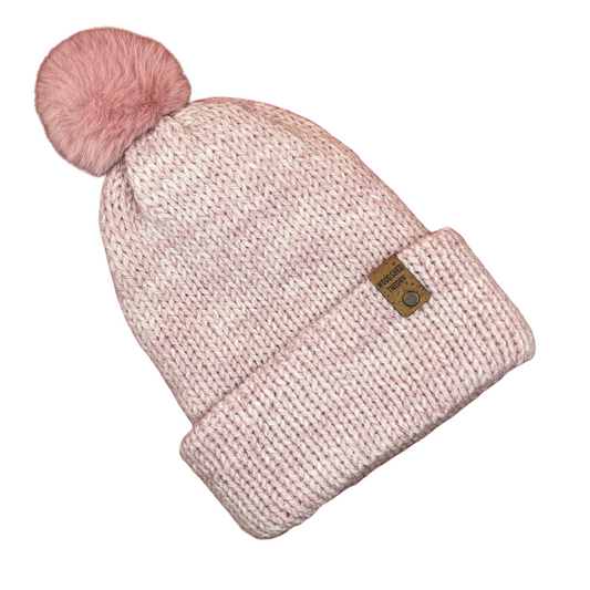 Pink knit beanie with a pom-pom on a white background the wooly beanie in pale pink front flat 