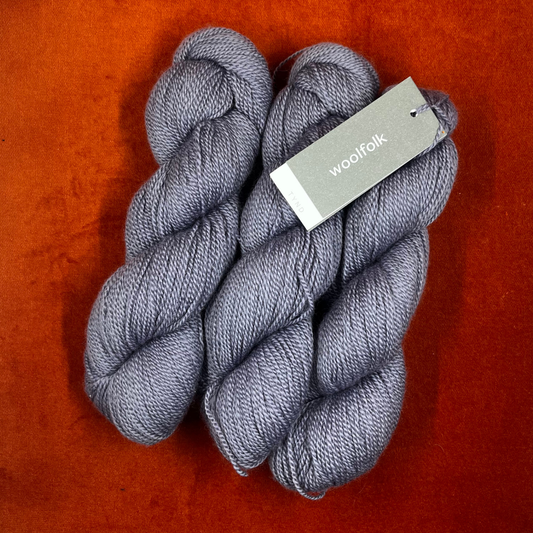 Three skeins of Woolfolk TYND yarn in Color 41 (periwinkle grey), fingering weight 100% Ovis 21 Merino wool. top down