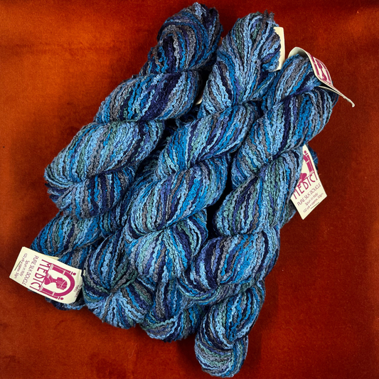 Crystal Palace Medici Pure Silk Boucle yarn in color 1492—bundle of 6 skeins in a mix of blues and greens, spun in Italy. top down