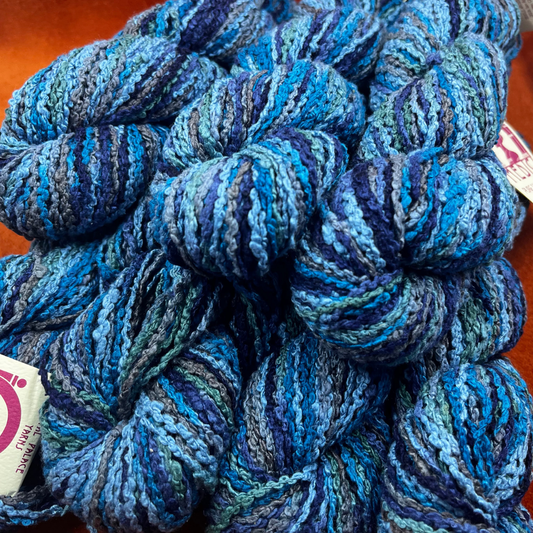 Crystal Palace Medici Pure Silk Boucle yarn in color 1492—bundle of 6 skeins in a mix of blues and greens, spun in Italy. close up 