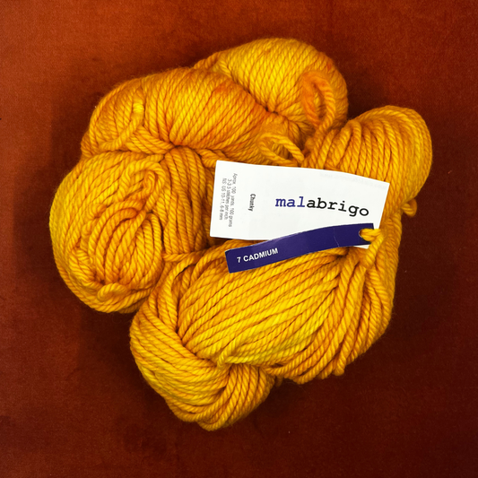 Two hanks of Malabrigo Chunky yarn in 7 Cadmium, a bright yellow 100% merino wool yarn, 200 yards total. top down