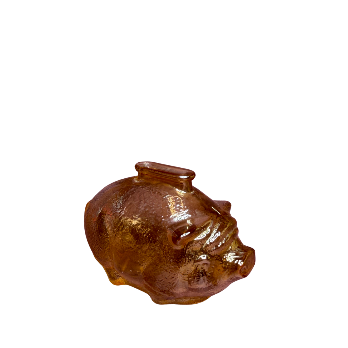 A small glossy pig-shaped container or figurine in translucent amber-brown glass, shown on a plain white background.