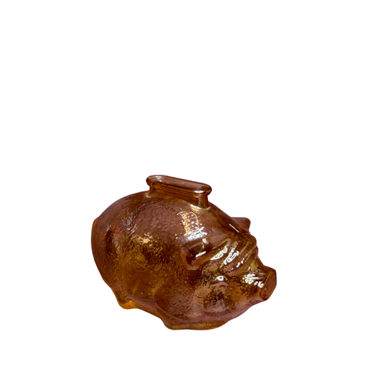 A small glossy pig-shaped container or figurine in translucent amber-brown glass, shown on a plain white background.