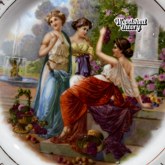 Antique Carl Schumann Bavaria decorative plate with reticulated edge, gold accents, and scene of three Grecian ladies in a garden, 7 inches. close up 