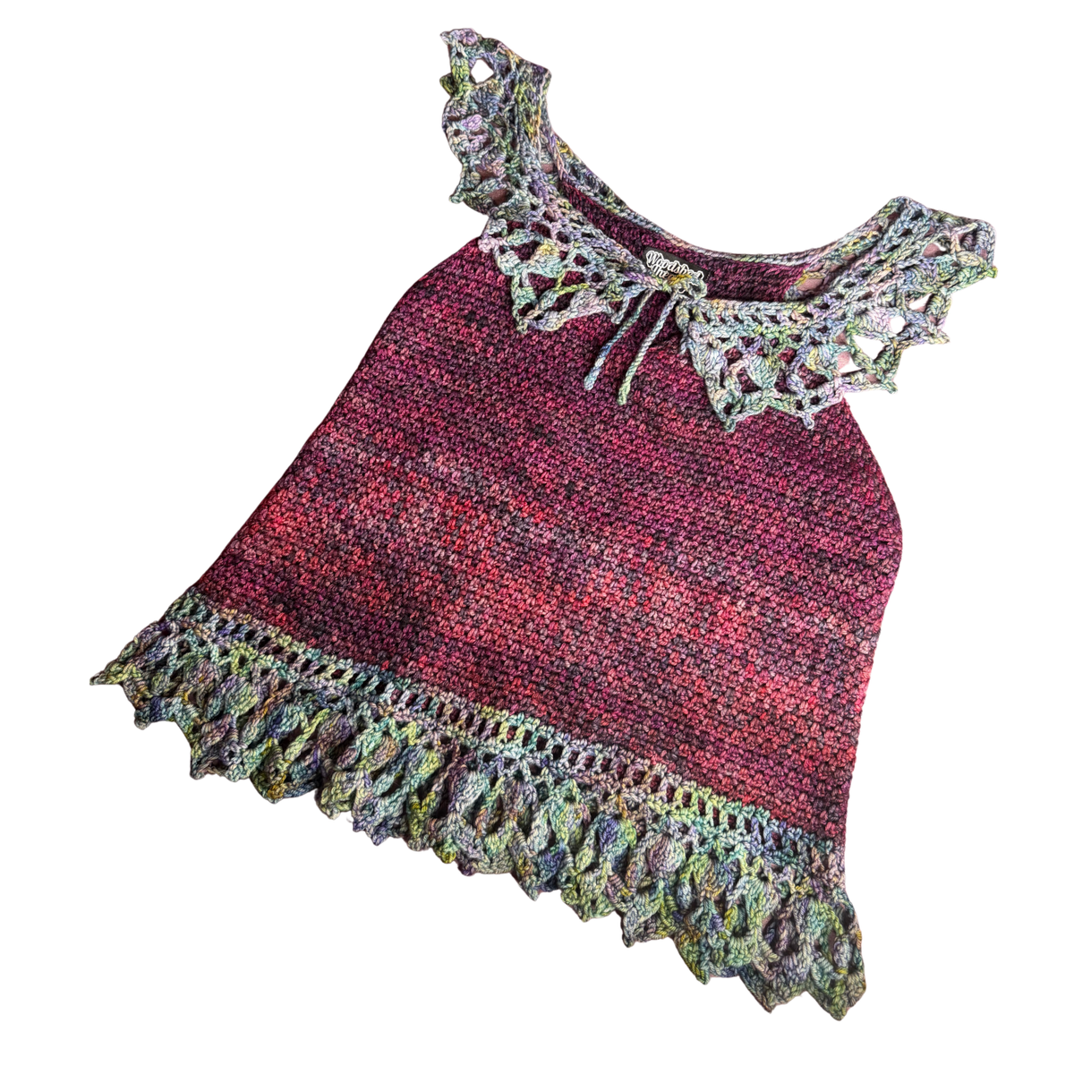 A handmade crochet top with a textured red and green variegated body, featuring a large lace ruffle collar with a tie and a matching lace ruffle hem, shown on a plain white background.