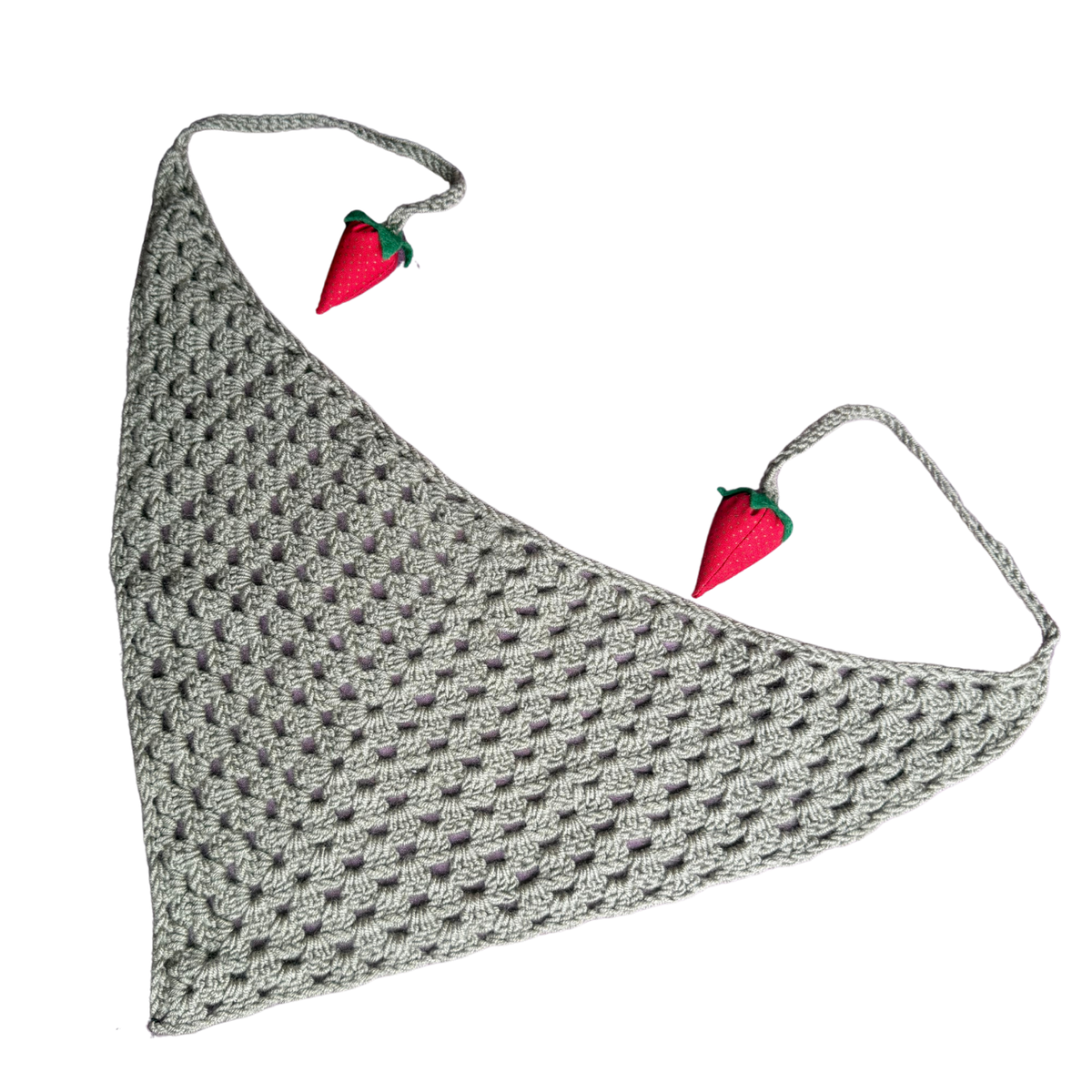 A sage green crochet pet bandana with two small strawberry embellishments on the ties, displayed on a solid white background.