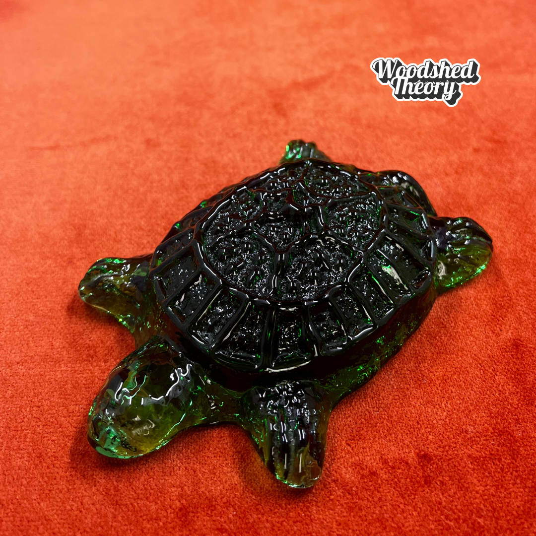 Hand-made Blenko glass turtle paperweight in dark green, crafted by artisans in West Virginia. Unique American art glass collectible. close up 