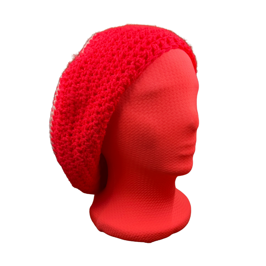 A bright red crocheted slouchy beanie hat displayed on a matching red mannequin head against a plain white background.