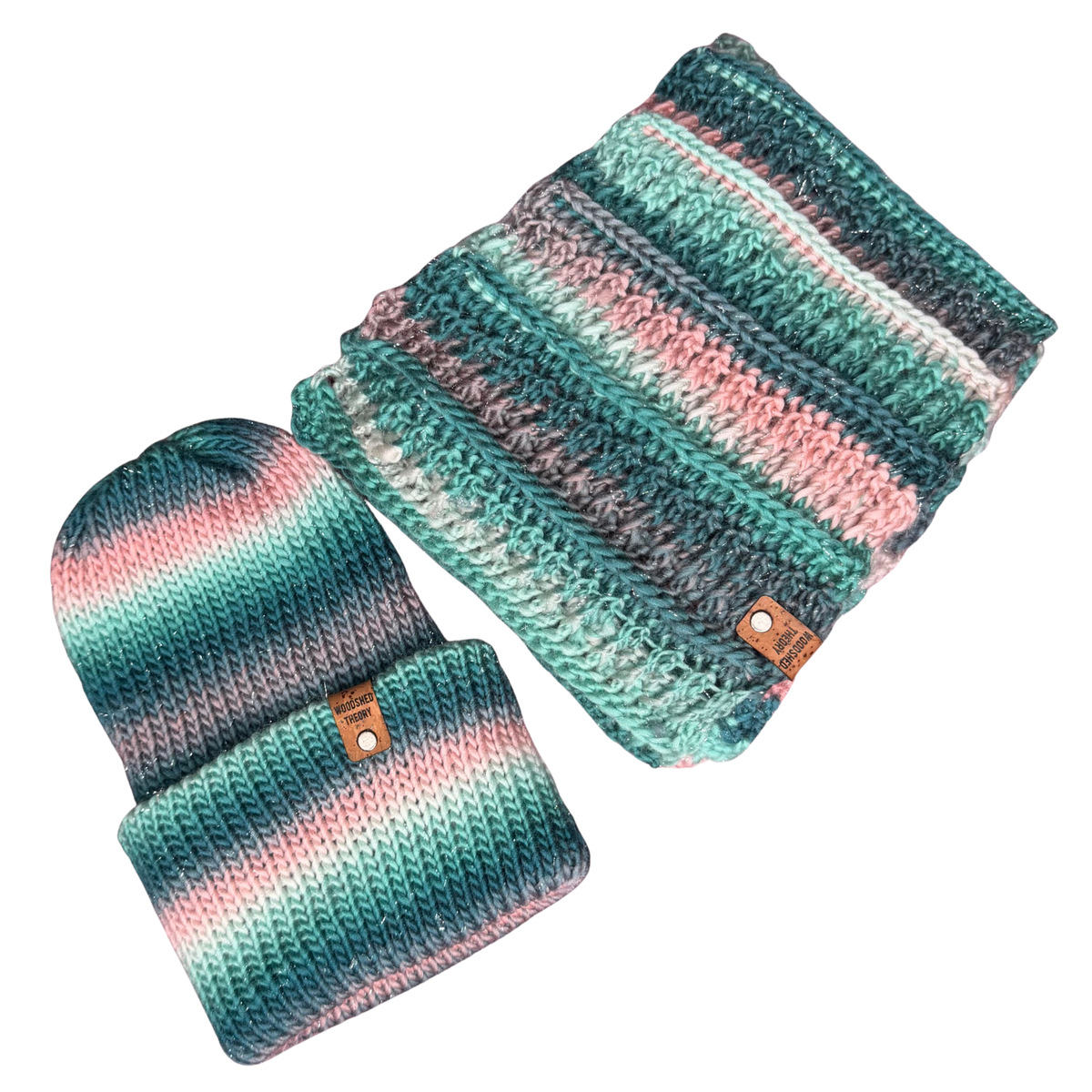 A matching knit beanie and scarf set with horizontal stripes in teal, pink, gray, and white, shown on a plain white background.
