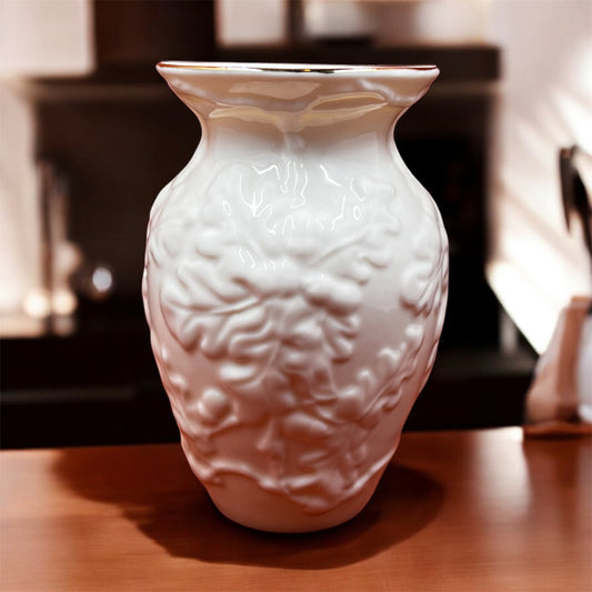 Vintage Belleek Irish porcelain mini vase with acorn and oak leaf design, gold rim, bone china, made in Ireland between 1997-2000, 5 inches tall. on table