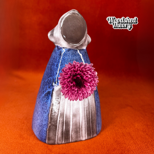 Vintage Swedish pottery flower holder designed by Elsi Bourelius for Jie Gantofta, featuring a ceramic girl figure with original stickers, circa mid-century. front with flower 
