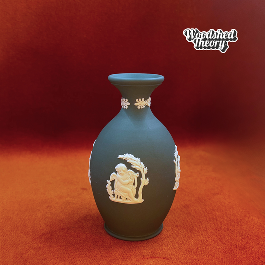 Jade green Wedgwood jasperware bud vase with white cherub and classical figure relief. Cherub playing harp 