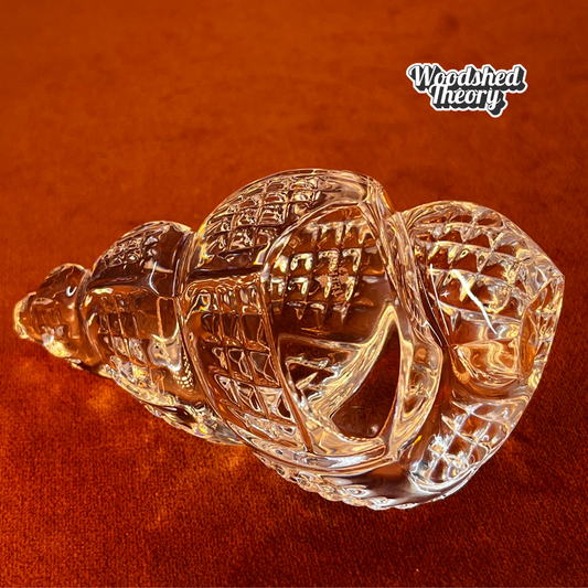 Clear Waterford Crystal conch shell paperweight with faceted design reflecting light; approx. 2.75” by 4.5”. close up 