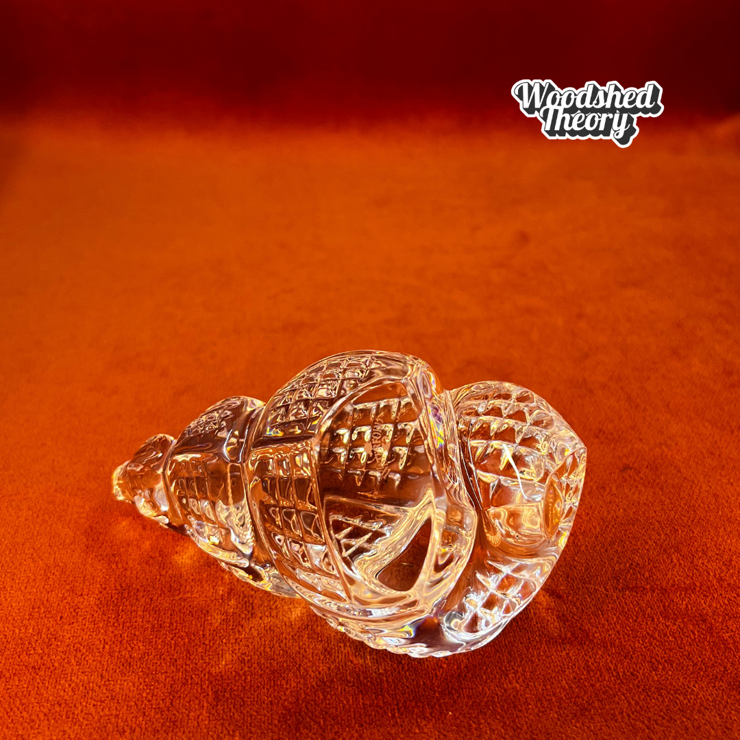 Clear Waterford Crystal conch shell paperweight with faceted design reflecting light; approx. 2.75” by 4.5”. bottom