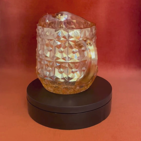 Vintage Jeannette Glass Company Buttons and Bows milk pitcher in iridescent amber, 1947–1949, with handle and shimmering finish. video spin